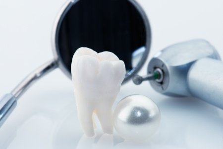 photo of dentist tools to do fillings and a tooth